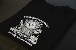 Folded T-Shirt mockup - I UNPLUGGED SOMETHING. NO BODY KNOWS WHAT. (MANUAL_MOTAA6M8) [dynamic_lifestyle]