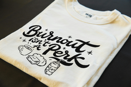 Folded T-Shirt mockup - Burnout Isn’t A Perk (CG628) [dynamic_lifestyle]