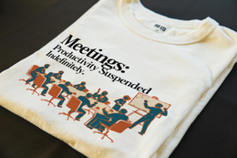 Folded T-Shirt mockup - Meetings: Productivity Suspended Indefinitely (CG1665) [dynamic_lifestyle]