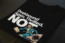 Folded T-Shirt mockup - Deskbound Again. Thrilled, Not. (CG3651) [dynamic_lifestyle] | v=1776104621462