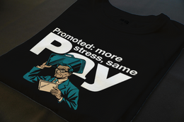 Folded T-Shirt mockup - Promoted: More Stress, Same Pay (CG3916) [dynamic_lifestyle] | v=1775233400084