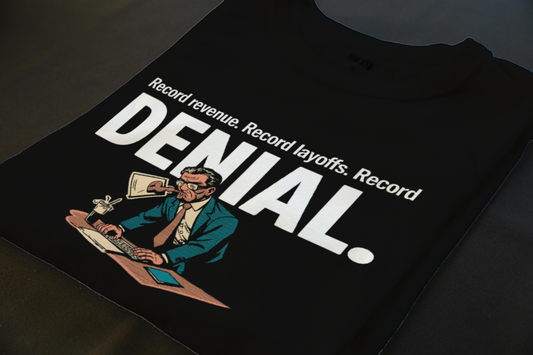 Folded T-Shirt mockup - RECORD REVENUE. RECORD LAYOFFS. RECORD DENIAL. (CG7996) [dynamic_lifestyle]