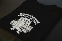 Folded T-Shirt mockup - THIS MEETING COULD HAVE BEEN AN EMAIL (MANUAL_MOT24507) [dynamic_lifestyle]