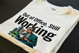 Folded T-Shirt mockup - Out Of Office, Still Working (CG904) [dynamic_lifestyle]